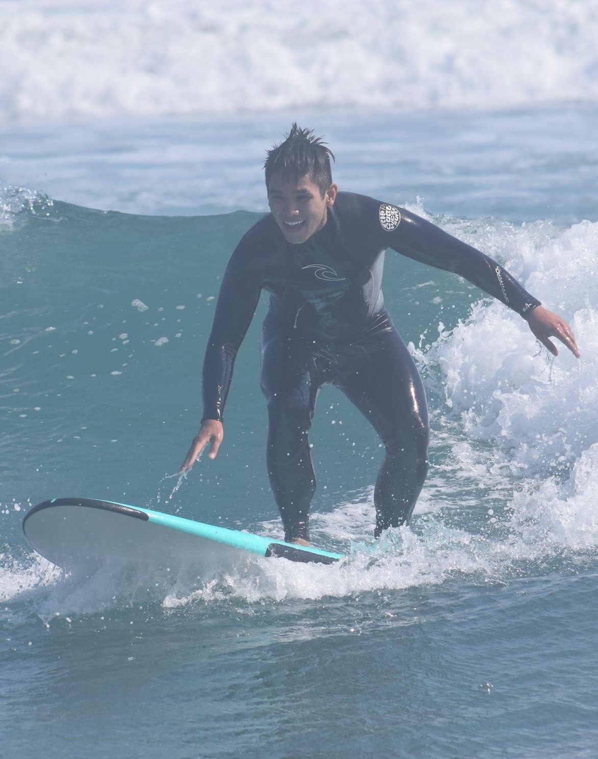 surfing instructor teaches youth