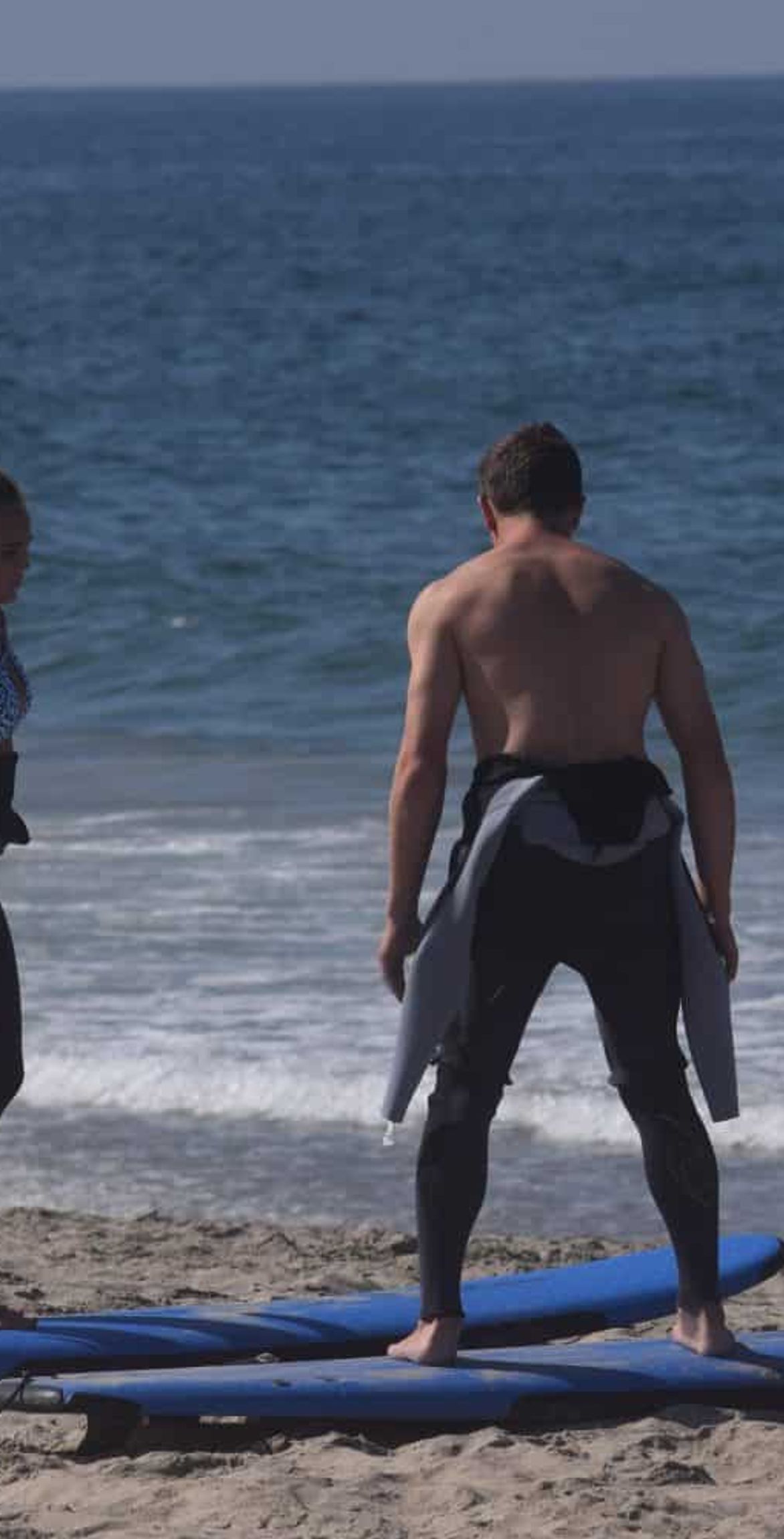 surfing instructor teaches youth